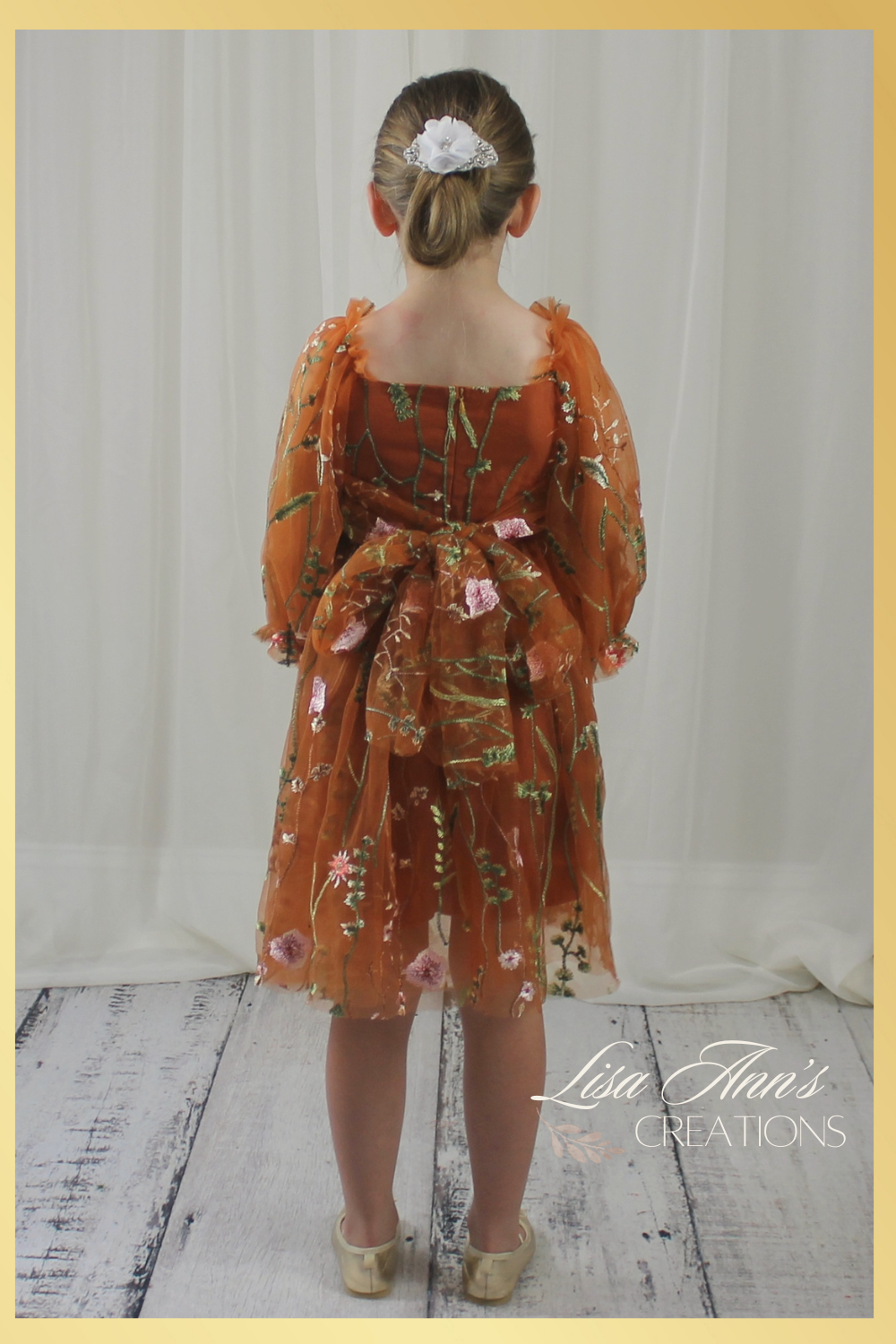 Back picture of Fall Floral girl dress in burnt orange floral embroidery with long tulle sleeves and knee length style.