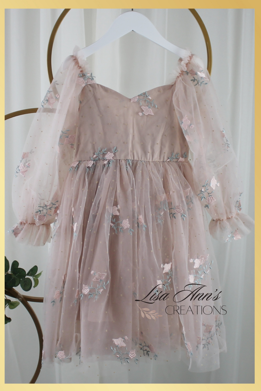Champagne flower girl dress with long sleeve tulle sleeves. made with a tulip embroidery flower and swiss dot pattern.