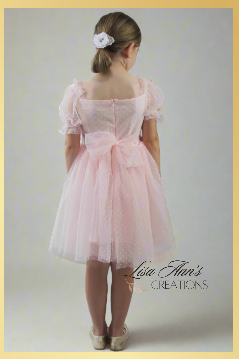 girls light pink dress made with swiss dot light pink tulle.