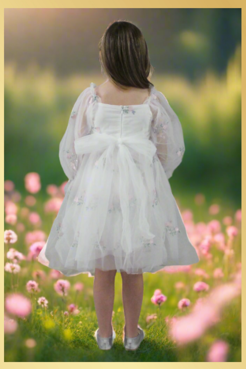 Back of girl flower girl dress in long sleeves. Made with a soft white tulle with a tulip embroidery flower. Made to be knee length and perfect for parties, weddings, and all special occasions.