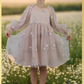 Champagne flower girl dress with long sleeve tulle sleeves. made with a tulip embroidery flower and swiss dot pattern. 