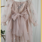 Back of dress. With zipper and tulle sash tied in a bow. Champagne flower girl dress with long sleeve tulle sleeves. made with a tulip embroidery flower and swiss dot pattern. 